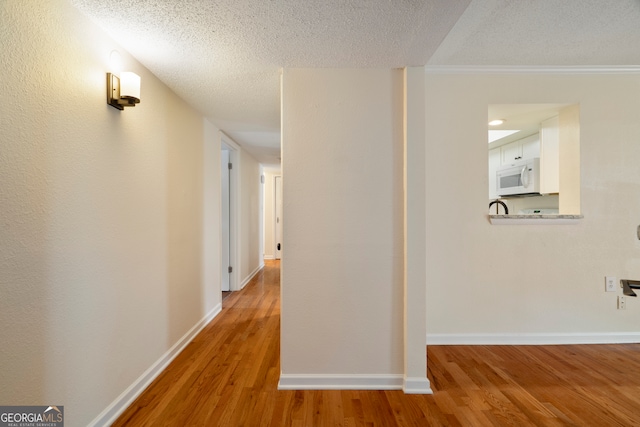 3301 Henderson Mill Rd Unit J1, Atlanta, GA 30341 - corridor featuring wood finished floors, a textured ceiling, and baseboards