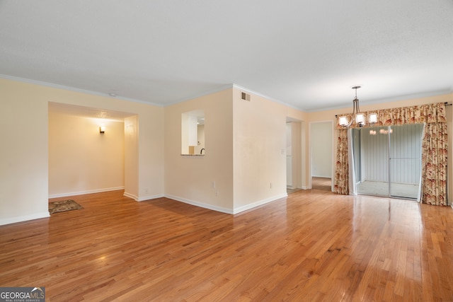 3301 Henderson Mill Rd Unit J1, Atlanta, GA 30341 - empty room with a chandelier, crown molding, light wood-style floors, and baseboards