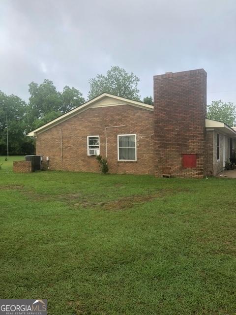 19470 Ga Highway 45, Arlington, GA 39813 - view of property exterior with a yard, central AC, and a chimney