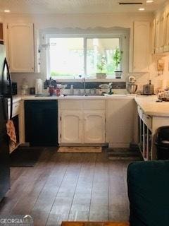 19470 Ga Highway 45, Arlington, GA 39813 - kitchen with black appliances, hardwood / wood-style floors, light countertops, and white cabinets