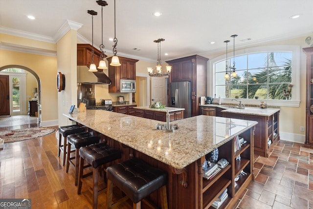 19410 Ga Highway 169, Claxton, GA 30417 - kitchen featuring stainless steel appliances, wall chimney range hood, baseboards, arched walkways, and a sink