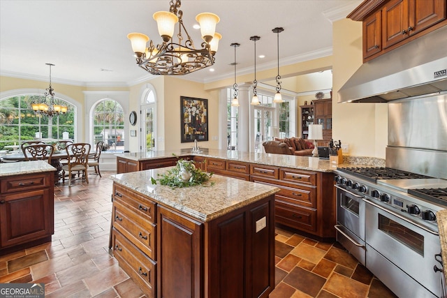 19410 Ga Highway 169, Claxton, GA 30417 - kitchen featuring range with two ovens, a chandelier, under cabinet range hood, light stone countertops, and a center island
