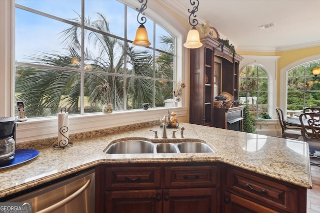 19410 Ga Highway 169, Claxton, GA 30417 - kitchen with a sink, stainless steel dishwasher, crown molding, pendant lighting, and light stone counters