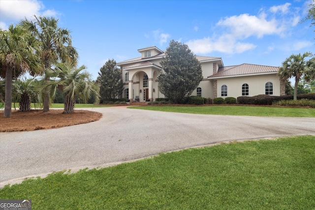 19410 Ga Highway 169, Claxton, GA 30417 - mediterranean / spanish home with curved driveway, stucco siding, a front yard, and a tiled roof