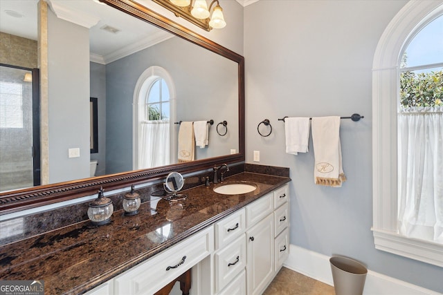 19410 Ga Highway 169, Claxton, GA 30417 - bathroom featuring plenty of natural light, ornamental molding, vanity, a shower, and baseboards
