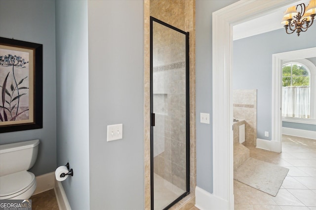 19410 Ga Highway 169, Claxton, GA 30417 - full bath featuring a shower stall, a chandelier, tile patterned floors, baseboards, and toilet