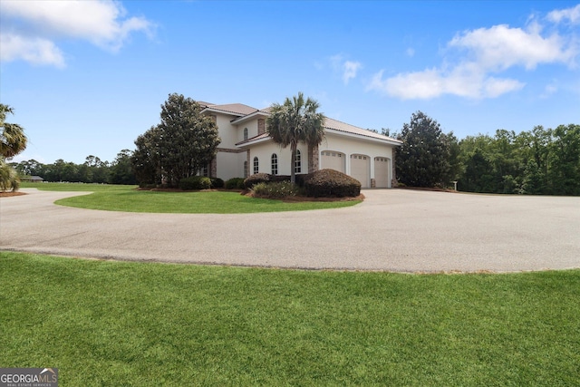 19410 Ga Highway 169, Claxton, GA 30417 - view of side of home featuring driveway, a lawn, a garage, and stucco siding