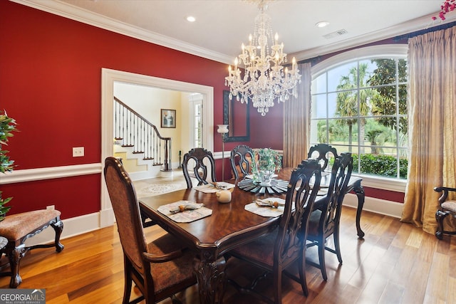 19410 Ga Highway 169, Claxton, GA 30417 - dining room featuring stairway, wood finished floors, crown molding, baseboards, and a chandelier