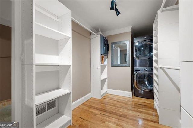 465 Willowbrook Dr, Smyrna, GA 30082 - laundry room with stacked washer / drying machine, light wood-type flooring, baseboards, and ornamental molding