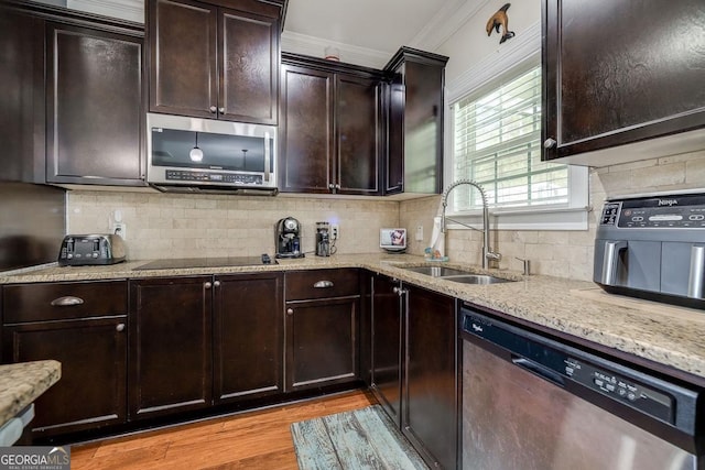 110 Bluegrass Cir, Guyton, GA 31312 - kitchen featuring stainless steel appliances, a sink, light stone countertops, backsplash, and light wood-style flooring