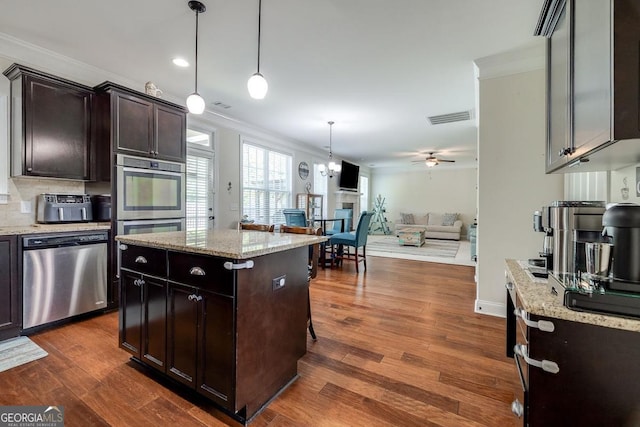 110 Bluegrass Cir, Guyton, GA 31312 - kitchen featuring appliances with stainless steel finishes, crown molding, open floor plan, ceiling fan, and pendant lighting