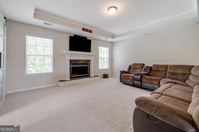 110 Bluegrass Cir, Guyton, GA 31312 - carpeted living room featuring a raised ceiling, ornamental molding, a premium fireplace, and baseboards