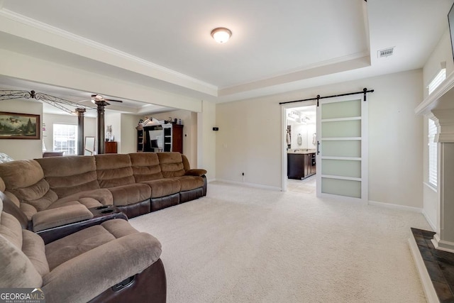 110 Bluegrass Cir, Guyton, GA 31312 - carpeted living room with a raised ceiling, baseboards, and a barn door