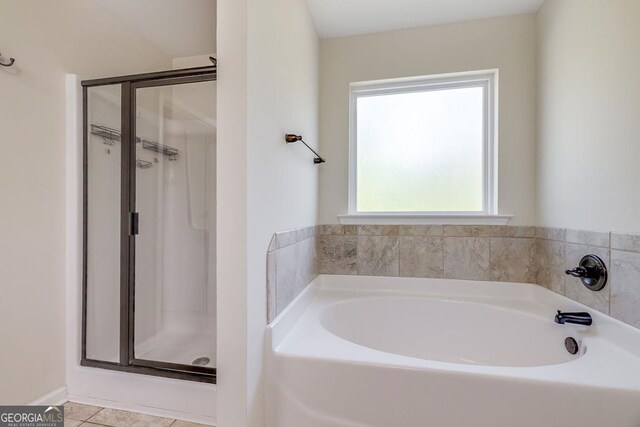 110 Bluegrass Cir, Guyton, GA 31312 - bathroom featuring a shower stall, a bath, and tile patterned flooring