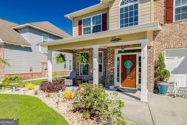 110 Bluegrass Cir, Guyton, GA 31312 - entrance to property with covered porch, brick siding, and a garage