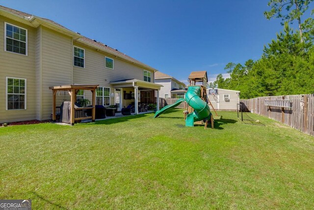 110 Bluegrass Cir, Guyton, GA 31312 - rear view of property with a playground and a patio area