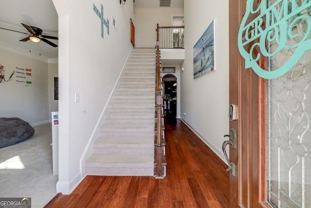 110 Bluegrass Cir, Guyton, GA 31312 - staircase with arched walkways, a ceiling fan, baseboards, crown molding, and wood finished floors