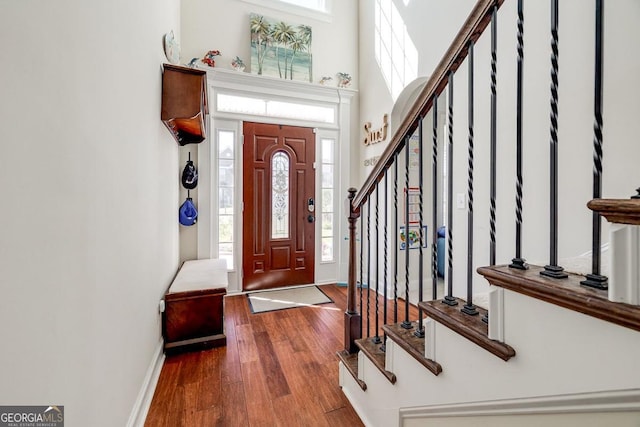 110 Bluegrass Cir, Guyton, GA 31312 - foyer featuring wood finished floors, stairway, a towering ceiling, and baseboards