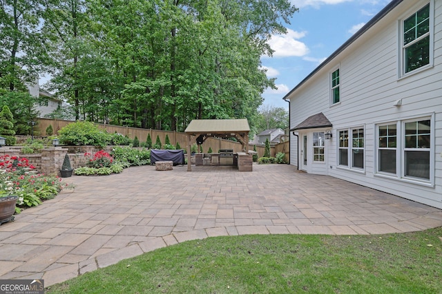 view of patio with a fenced backyard and a gazebo