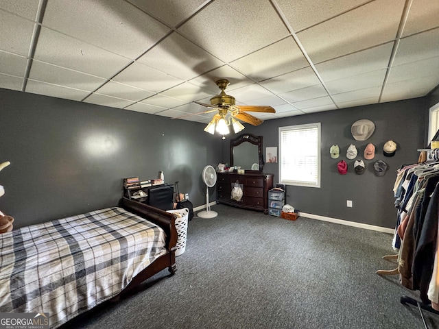 bedroom featuring a paneled ceiling, carpet floors, baseboards, and a ceiling fan