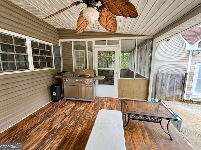 unfurnished sunroom featuring a ceiling fan