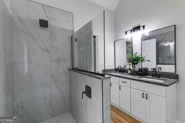 130 Opal Ln, Carrollton, GA 30116 - bathroom featuring a marble finish shower, double vanity, wood finished floors, and vaulted ceiling
