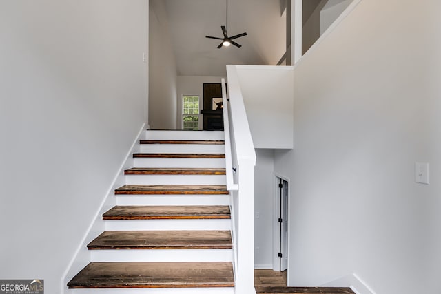 130 Opal Ln, Carrollton, GA 30116 - staircase featuring ceiling fan, a towering ceiling, baseboards, and wood finished floors