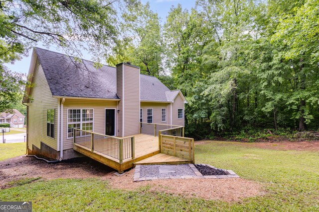 130 Opal Ln, Carrollton, GA 30116 - back of house with a wooden deck, a chimney, a yard, and roof with shingles