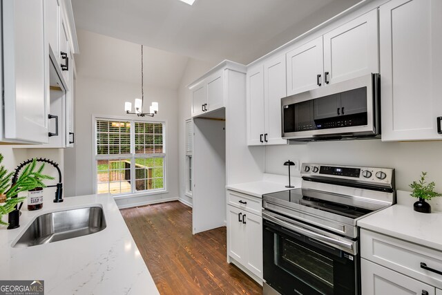 130 Opal Ln, Carrollton, GA 30116 - kitchen featuring appliances with stainless steel finishes, a sink, dark wood-type flooring, a chandelier, and white cabinetry