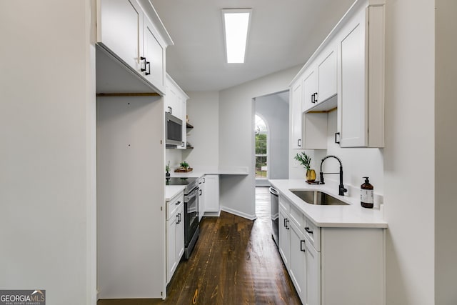 130 Opal Ln, Carrollton, GA 30116 - kitchen with a sink, stainless steel appliances, dark wood-style floors, light countertops, and white cabinetry