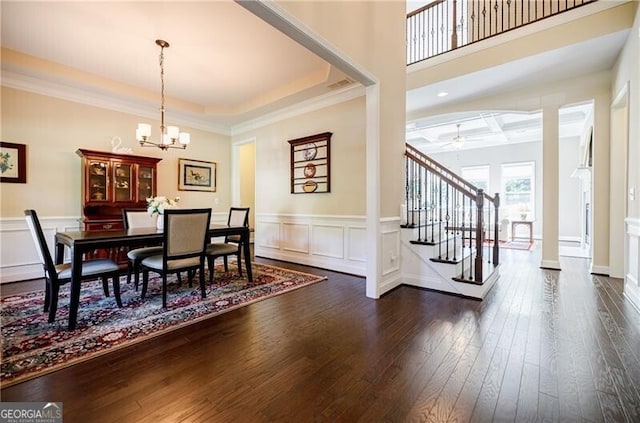 468 Scott Farm Dr, Powder Springs, GA 30127 - dining space featuring stairway, a chandelier, dark wood finished floors, wainscoting, and a decorative wall