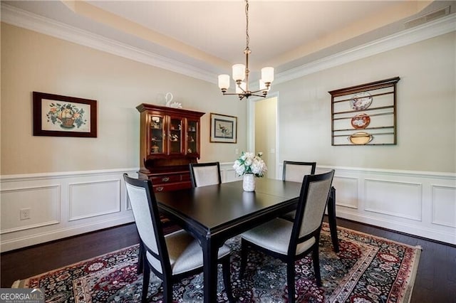 468 Scott Farm Dr, Powder Springs, GA 30127 - dining space featuring a chandelier, dark wood-style flooring, crown molding, a wainscoted wall, and a tray ceiling