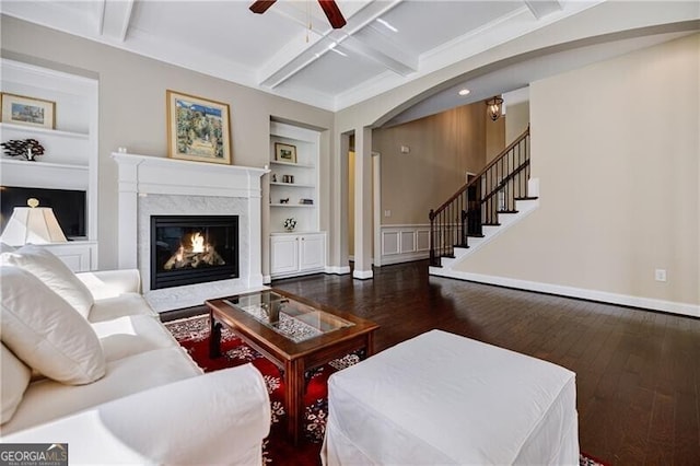 468 Scott Farm Dr, Powder Springs, GA 30127 - living area with built in shelves, wood-type flooring, ceiling fan, coffered ceiling, and beamed ceiling