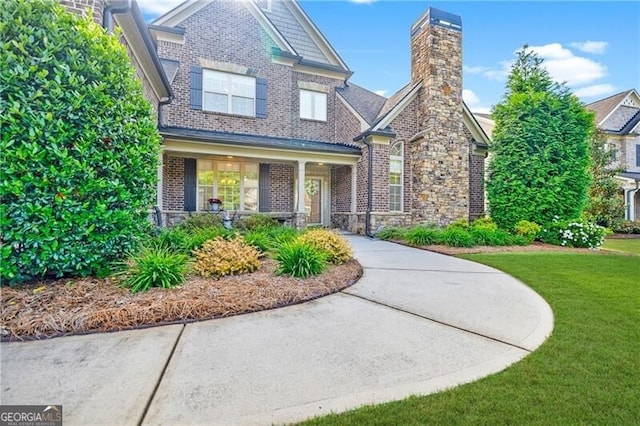 468 Scott Farm Dr, Powder Springs, GA 30127 - craftsman house featuring a front yard, brick siding, a chimney, and stone siding
