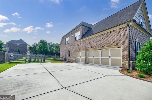 468 Scott Farm Dr, Powder Springs, GA 30127 - view of side of home with driveway, brick siding, an attached garage, and roof with shingles