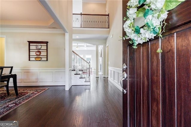468 Scott Farm Dr, Powder Springs, GA 30127 - foyer entrance featuring stairs, crown molding, dark wood finished floors, wainscoting, and ceiling fan