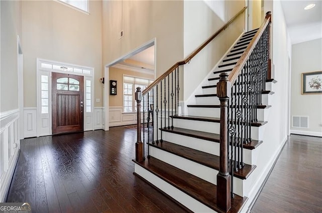 468 Scott Farm Dr, Powder Springs, GA 30127 - foyer entrance with wood finished floors, wainscoting, a decorative wall, stairway, and a towering ceiling