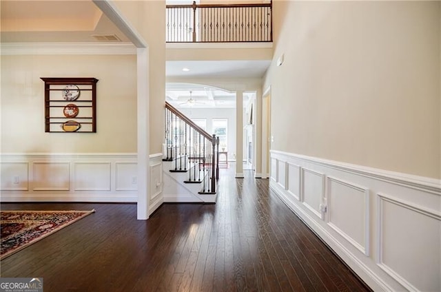 468 Scott Farm Dr, Powder Springs, GA 30127 - foyer featuring stairs, ceiling fan, a decorative wall, dark wood-style flooring, and a wainscoted wall