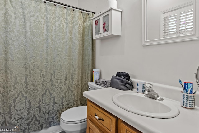 full bathroom featuring toilet, vanity, and a shower with shower curtain