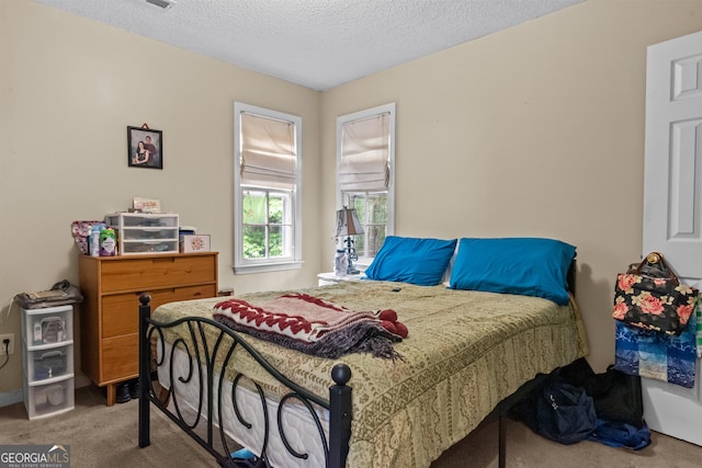 carpeted bedroom with a textured ceiling