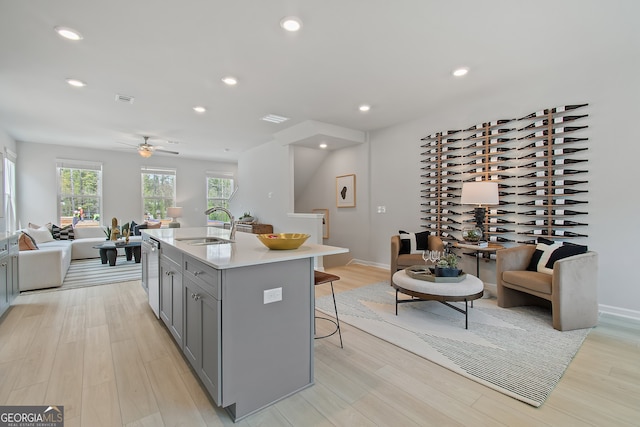 3142 Washburn St, Atlanta, GA 30354 - kitchen featuring gray cabinets, a sink, open floor plan, a kitchen breakfast bar, and light countertops
