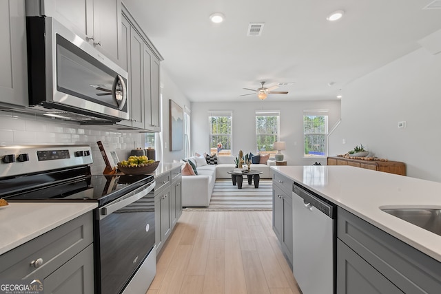 3142 Washburn St, Atlanta, GA 30354 - kitchen featuring stainless steel appliances, gray cabinets, open floor plan, and recessed lighting