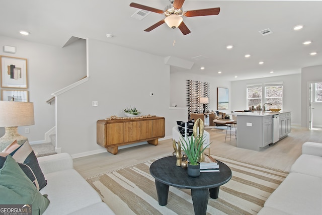 3142 Washburn St, Atlanta, GA 30354 - living room featuring light wood-style flooring, a ceiling fan, recessed lighting, baseboards, and stairs