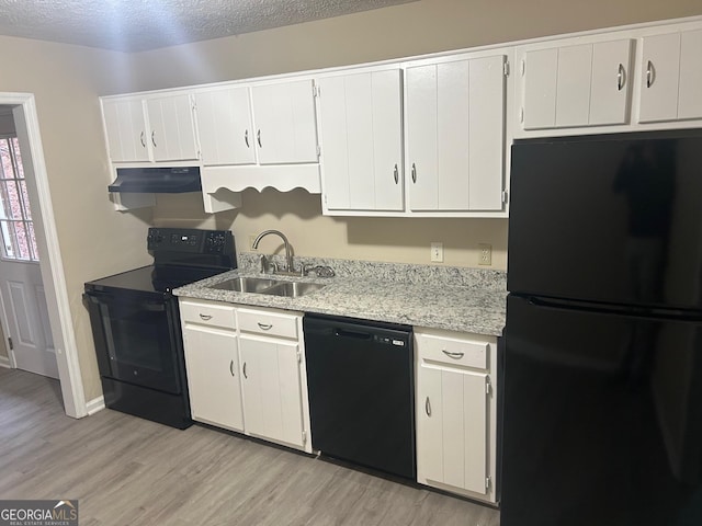 72 N Ridge Ct SW, Rome, GA 30165 - kitchen featuring black appliances, a sink, under cabinet range hood, light wood-style floors, and white cabinets