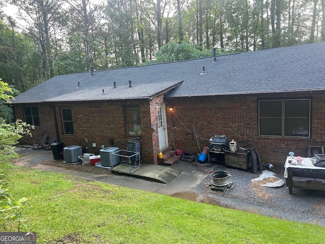 72 N Ridge Ct SW, Rome, GA 30165 - rear view of house with a shingled roof, brick siding, and a patio area