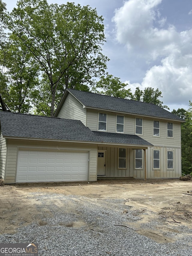 1016 Redfield Way, Jasper, GA 30143 - view of front facade with board and batten siding, dirt driveway, a garage, and a shingled roof