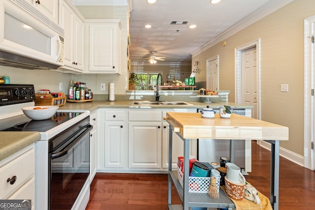 kitchen with range with electric stovetop, a sink, white microwave, a ceiling fan, and recessed lighting
