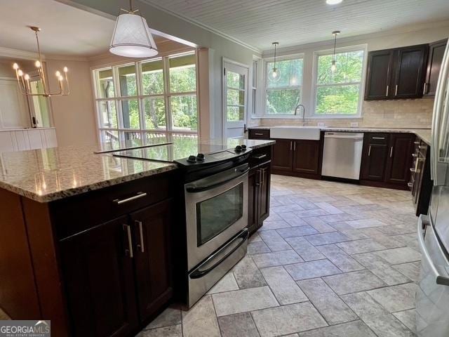 617 Smith St S, Bremen, GA 30110 - kitchen with stainless steel appliances, a sink, a chandelier, backsplash, and light stone counters