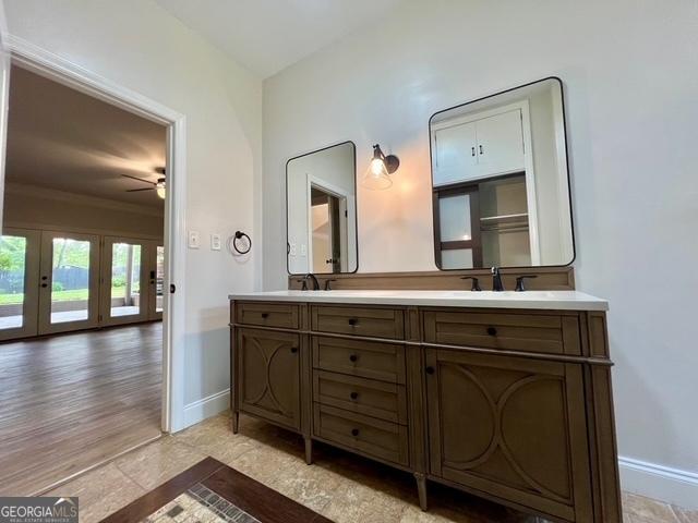 617 Smith St S, Bremen, GA 30110 - bathroom with baseboards, ceiling fan, double vanity, french doors, and crown molding