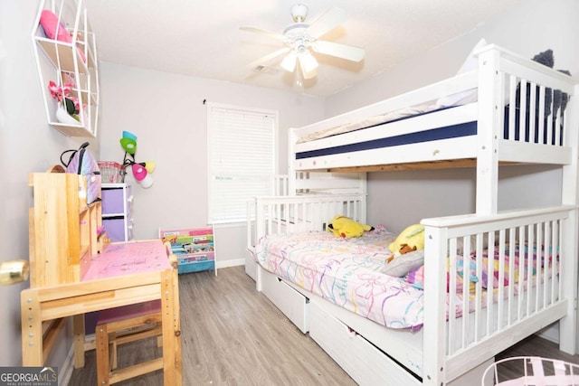 bedroom featuring wood finished floors and baseboards